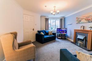 a living room with a couch and a fireplace at Charming 3 Bedroom, 2 Bathroom Home in Northampton - SKY TV included, Free Parking & WiFi by HP Accommodation in Northampton