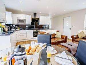 a kitchen and living room with a table with food on it at 2 bed in Aberaeron 75211 in Mydroilin
