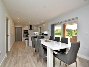 a kitchen and dining room with a white table and chairs at 4 bed in Oswestry 73291 in Kinnerley