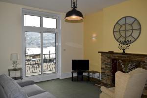 a living room with a fireplace and a television at Harbourside 1 in Dartmouth