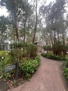 a path through a park with a sign and trees at Forest Villa 330 Flamingo Dai Lai in Ngọc Quang