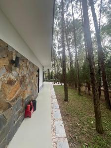 a building with a stone wall and a walkway at Forest Villa 330 Flamingo Dai Lai in Ngọc Quang