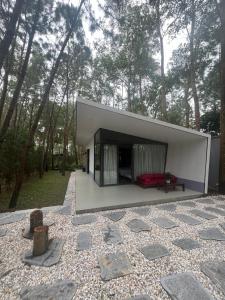 a house with a red couch in the middle of a yard at Forest Villa 330 Flamingo Dai Lai in Ngọc Quang