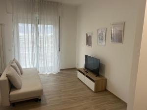 a living room with a couch and a television at A Ca' di Giulietto in Albenga