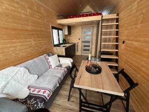 a living room with a couch and a table at Challet44 in Jeseník +24 photos