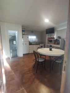 a kitchen and dining room with a table and chairs at Mar de Cobo casa en alquiler temporario in Mar de Cobo +26 photos