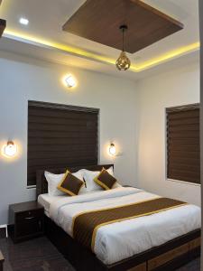 a bedroom with a large bed with two pillows at Windgram Homestay in Ambalavayal