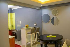a kitchen with a table and two mirrors on the wall at The Hidden gem Near Acacia Mall, 2 BDRs in Kampala