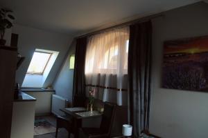 a living room with a table and a window at APARTMÁNY PIETRO in Oravský Podzámok