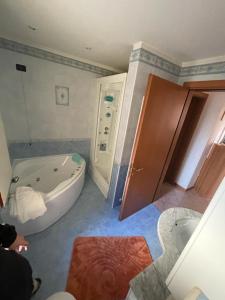 a bathroom with a tub and a sink and a bath tub at HOUSE 58 in Montaner