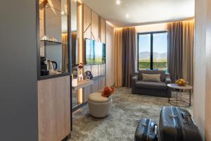 a living room with a couch and a chair at Atmosphere Balneo Hotel & SPA in Pavel Banya