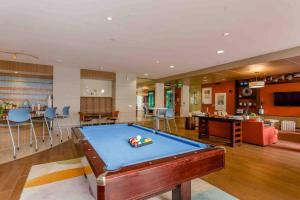 a living room with a pool table in it at Cozy Oasis Pool Gym Wi-Fi Pets OK Near NRG in Houston