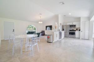 a kitchen and dining room with a table and chairs at The Retreat #8231 in West Palm Beach
