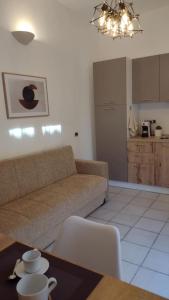 a living room with a couch and a table at LechicchediLampedusa in Lampedusa