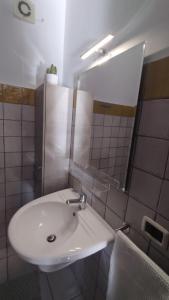 a bathroom with a white sink and a mirror at LechicchediLampedusa in Lampedusa