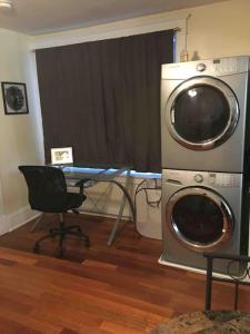 a washing machine and a desk in a room at The luxury lounge in Schenectady +12 photos