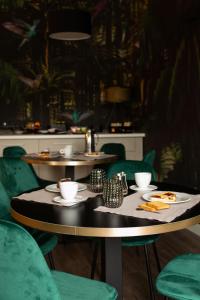 two tables in a restaurant with plates of food on them at Trepiasì in Cortemilia