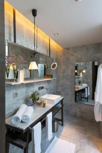 a bathroom with a sink and a mirror at André et Viviane Chatelard - Chambres d'hôtes in Saint-Bonnet-le-Froid