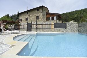 a large swimming pool in front of a house at B&B A…Monte in Santa Maria
