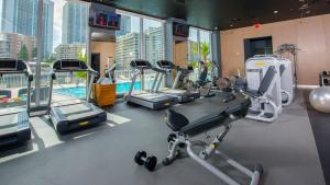 a gym with several tread machines and a pool at Amazing looking studio 5 min from Ocean near Aventura Mall and Gulfstream casino SPECIAL PROMO INSIDE in Hallandale Beach