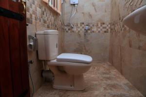 a bathroom with a toilet and a sink at River Edge Yala in Tissamaharama