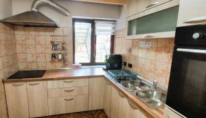 a small kitchen with a sink and a stove at Casa Nella in Braşov