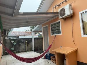 a patio with a hammock and a air conditioner at Lohighfive in Florianópolis