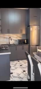 a kitchen with stainless steel appliances and white cabinets at Argavand home in Yerevan
