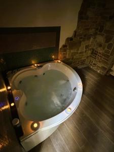 a large bath tub with lights in a bathroom at Torre Paola Dimora romantica in Acquasparta