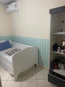 a hospital room with a bed in a room with a shelf at Lohighfive in Florianópolis