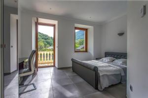 ein Schlafzimmer mit einem Bett und einem großen Fenster in der Unterkunft Domaine au cœur des 3 vallées in Moutiers