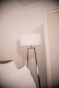 a lamp sitting next to a bed in a room at Maria's Premium Suite in Baia Mare