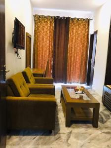 a living room with a couch and a coffee table at Pakeeza One Hotel in Lahore