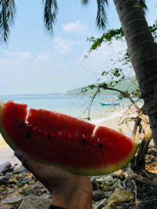 a person is holding a slice of watermelon at Villa Dilinga in Galle