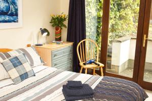 a bedroom with a bed and a dresser and a window at Kieran's Place in Dublin