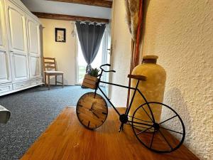 a vase sitting on a wooden floor next to a bike at Tiny-House No.3 in Lage