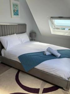 a bedroom with a large bed with a window at Brixham View House in Torquay