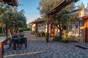 a patio with tables and chairs and a building at B&B La dimora in Albidona