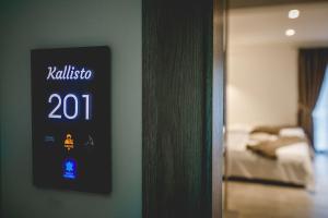 a hotel room with a sign on the wall at Naias Nemeia Luxury Rooms in Neméa