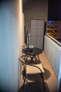 a small table and a chair on a balcony at Maria's Premium Suite in Baia Mare