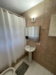 a small bathroom with a sink and a toilet at Hermosa casa zona céntrica Bariloche in San Carlos de Bariloche