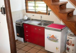 a small kitchen with a sink and a refrigerator at Bosque & Mar in Mar del Plata +10 photos