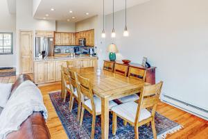 a kitchen with a wooden table and chairs at The Village Ski In Ski Out in Beaver Creek
