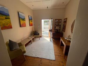 a living room with a couch and a table at Unique Guest House in Hallack Rock