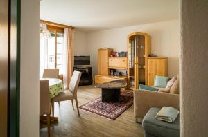 a living room with a couch and a table at Landwasser in Davos