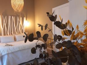 Un dormitorio con una cama con una planta al lado en El Vallín de Lan, en Cerezales del Condado