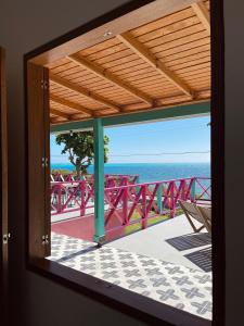 a room with a view of the ocean from a balcony at Seaflower Boutique lodge in Providencia