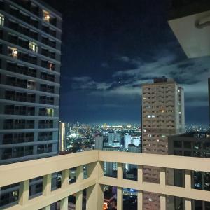 a view of a city skyline at night at 1BR Aesthetic Condotel with Balcony - EDSA in Manila