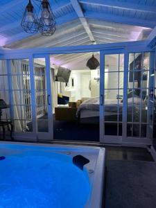 a room with a swimming pool and a bedroom at Apartment on 32 in Cape Town