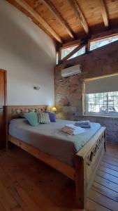 um quarto com uma cama grande num edifício em Cabaña Quinta La Gringa, San Rafael em São Rafael
